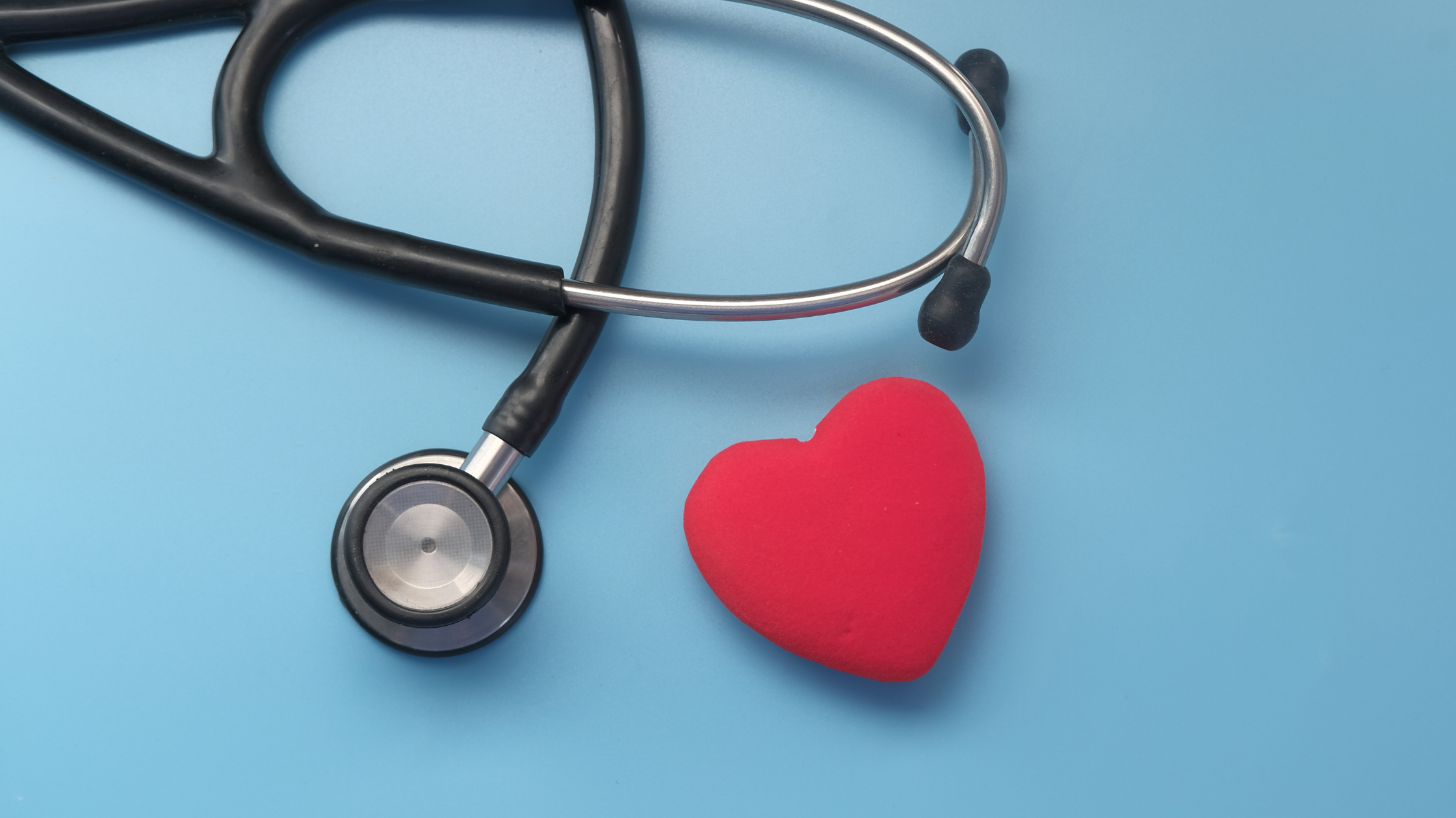 A stethoscope with a red heart shape next to it