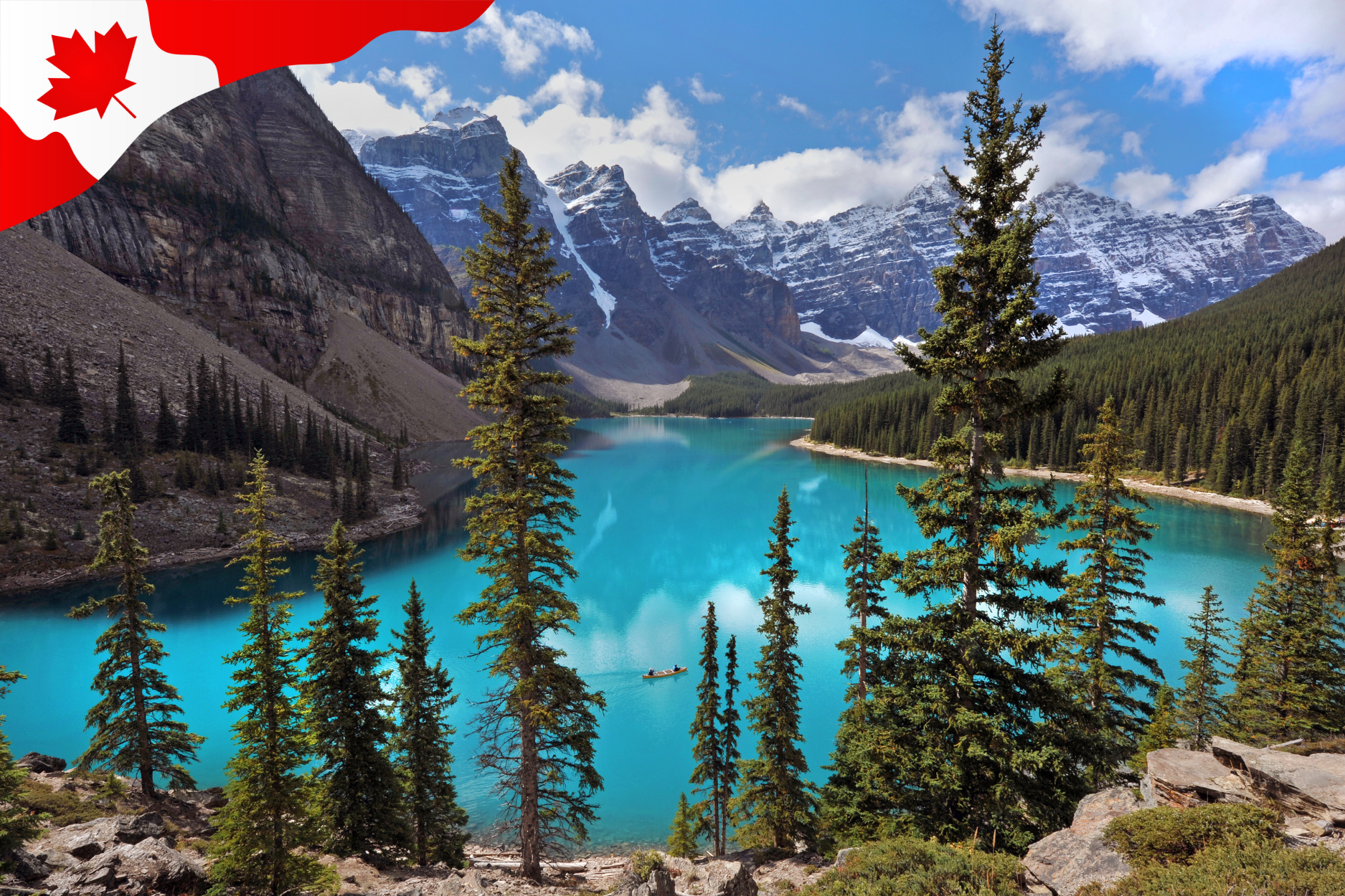 A view of a blue lake with mountains in the back and trees in the front