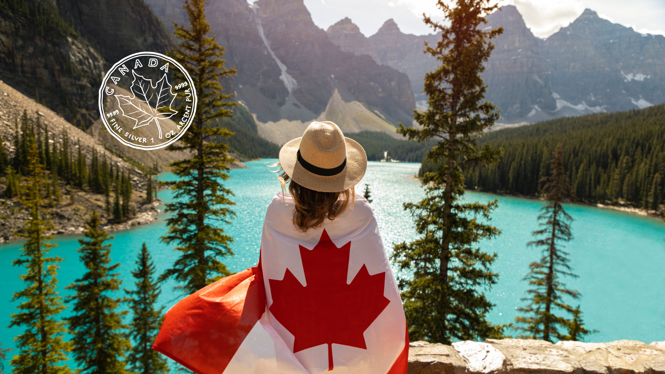 A person wearing a hat with a Canadian flag wrapped around them looking out over a lake