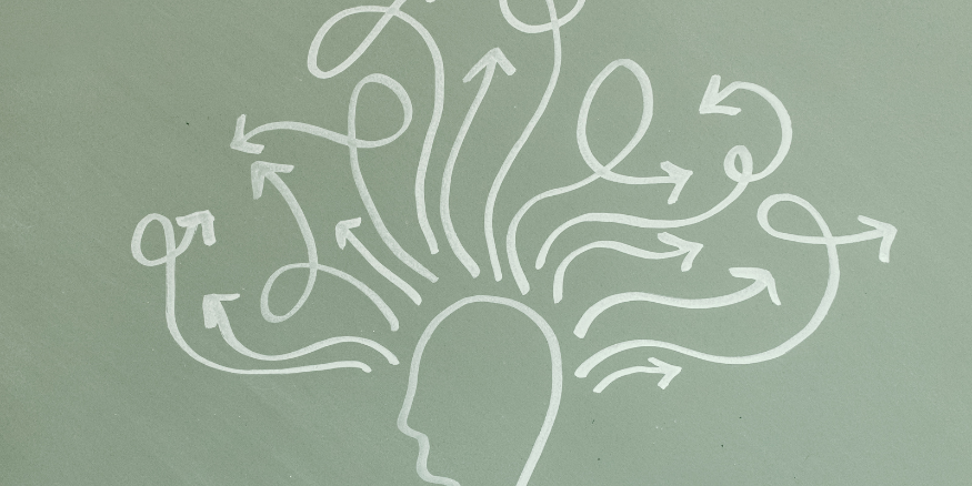 An outline of a head with arrows coming out from the top all pointing in different directions